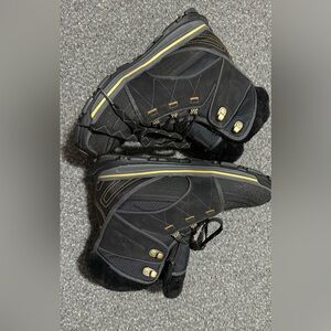 Black winter boots with gold accents and a fleece lining.Lace up style.